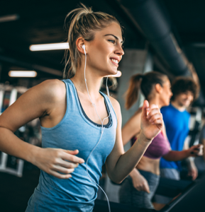 Young women running on a treadmill in a gym
